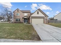 Charming two-story brick home with a well-maintained lawn and a two-car attached garage at 17879 Sandy Run Ct, Noblesville, IN 46062