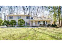 Charming two-story home featuring a covered front porch and well-maintained landscaping, plus neutral siding at 412 Tulip Dr, Mooresville, IN 46158