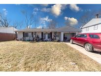Charming single-story home with a well-maintained front yard and attached garage at 4138 Richelieu Rd, Indianapolis, IN 46226