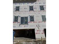 Exterior of an unfinished home with visible windows and a covered entrance, still under construction at 5740 Birtz Rd, Lawrence, IN 46216