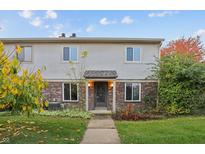 Inviting two-story townhome with brick accents and a well-manicured lawn at 6026 Oakbrook Ln, Indianapolis, IN 46254