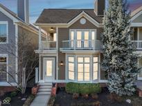 Charming two-story home featuring a private balcony, bay window, and beautifully landscaped front yard at 645 Ellsworth St, Indianapolis, IN 46202