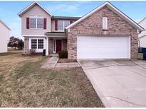Charming two-story home featuring brick accents, a two-car garage, and a well-manicured front lawn at 6454 Waterstone Dr, Indianapolis, IN 46268