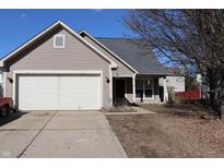 Charming home featuring neutral siding, attached garage, and well-maintained lawn at 6468 Oyster Key Ln, Plainfield, IN 46168