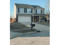 Charming two-story home featuring a two-car garage and a welcoming front porch at 7018 Allegan Dr, Indianapolis, IN 46217