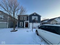 Charming two-story home featuring a red front door and a basketball hoop in the driveway at 9613 W Stargazer Dr, Pendleton, IN 46064