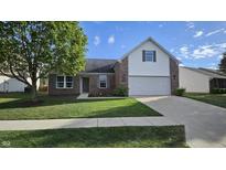 Charming single-Gathering home featuring brick accents, a two-car garage, and a well-maintained lawn at 10645 Aspen Dr, Fishers, IN 46037