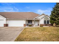 Charming single-story home featuring a well-manicured lawn and attached two car garage at 1114 Northfield Ln, Anderson, IN 46011