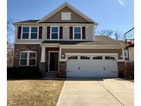 Charming two-story home with stone accents, red shutters and a two car garage at 12461 Hawks Landing Dr, Fishers, IN 46037