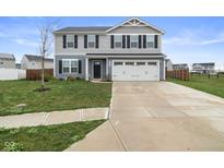 Attractive two-story home with a well-maintained lawn and a two-car garage at 13860 N Tiosa Ln, Camby, IN 46113