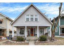 Charming home featuring a peaked roof, front porch, and manicured landscaping at 139 S Ritter Ave, Indianapolis, IN 46219