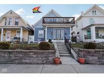 Charming two-story home features an upper deck, a welcoming entrance, and curb appeal at 1413 S East St, Indianapolis, IN 46225