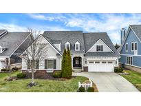 Charming two-story home with landscaped front yard and attached two car garage at 15745 Market Center Dr, Carmel, IN 46033