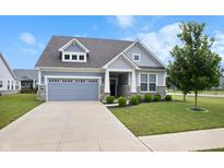 Charming single Gathering home with a well-maintained lawn and a two-car garage at 16401 Brigham Ln, Westfield, IN 46074
