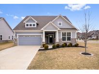 Charming single-Gathering home showcasing a well-manicured lawn, neutral color palette and an attached garage at 16401 Brigham Ln, Westfield, IN 46074