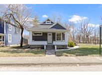 Charming craftsman home with a welcoming front porch, gray siding, and manicured lawn on a sunny day at 1701 Barth Ave, Indianapolis, IN 46203
