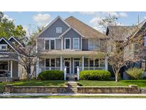 Charming two-story home featuring a welcoming front porch and well-manicured lawn at 2016 Central Ave, Indianapolis, IN 46202