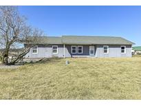Charming single-story home featuring a clean gray exterior, complemented by well-maintained landscaping and a sunny, inviting lawn at 22569 State Road 37 N, Noblesville, IN 46060