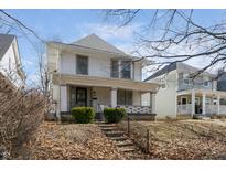 Charming two-story home with a covered front porch and landscaped front yard at 2823 Boulevard Pl, Indianapolis, IN 46208