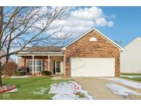 Charming single Gathering home featuring a brick facade, two car garage, and a well maintained front yard at 2934 Lodgepole Dr, Whiteland, IN 46184