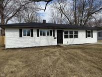 Charming single-story home with a freshly painted white exterior and black accents on a sunny, winter day at 5546 Marilyn Rd, Indianapolis, IN 46226