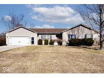 Charming single-story home with a well-maintained front yard and attached two-car garage at 5620 E Sunshine Ct, Mooresville, IN 46158