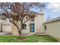 Inviting front exterior showcasing a stone facade, well-maintained lawn, and mature tree at 5762 Overcrest Dr, Indianapolis, IN 46237