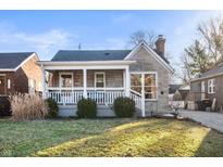 Charming home featuring a stone facade, covered porch, well-maintained landscaping, and a cozy curb appeal at 6225 Indianola Ave, Indianapolis, IN 46220