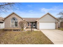 Charming single-Gathering home featuring a two-car garage, brick accents, and a well-manicured front lawn at 649 Sweet Creek Dr, Indianapolis, IN 46239