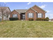 Charming brick home featuring well-maintained lawn, mature shrubs, and inviting front entrance at 657 Brandi Ct, Greenwood, IN 46142
