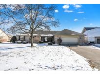 Charming brick ranch with a manicured lawn and mature trees, complete with an attached two-car garage and beautiful curb appeal at 8329 Hill Gail Dr, Indianapolis, IN 46217