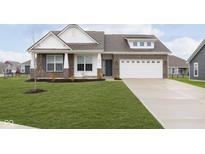 Charming two-story home with a brick and siding exterior and a well-manicured lawn at 1030 Macoun Dr, Westfield, IN 46074