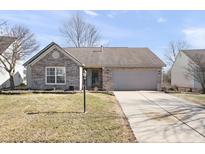 Charming single-story brick home with a well-maintained lawn and an attached two-car garage and concrete driveway at 10373 Cerulean Dr, Noblesville, IN 46060