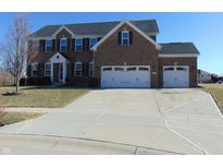 Brick two-story home with a three-car garage and a large concrete driveway at 1211 Worcester Ct, Greenwood, IN 46143