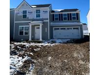 Charming two-story home featuring a welcoming entrance, garage, and symmetrical window design at 13820 N Fairwood Dr, Camby, IN 46113