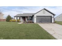 Charming one-story home featuring gray siding, a gray garage door, and a well-manicured lawn at 17215 Meggs St, Westfield, IN 46062