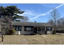 Charming single-story home with a well-maintained lawn and mature trees on a partly sunny day at 251 S 12Th Ave, Beech Grove, IN 46107