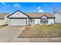 Charming single-story home featuring a garage, well-maintained lawn, and attractive curb appeal at 2622 N Tacoma Ave, Indianapolis, IN 46218