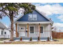 Charming renovated home featuring a covered porch with updated railings and a fresh blue and gray color scheme at 2626 E 18Th St, Indianapolis, IN 46218