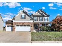 Charming two-story home with a manicured lawn, a two car garage, and a covered porch at 2912 Tuscarora Ln, Indianapolis, IN 46217