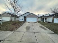 Well-maintained home with a two-car garage and a freshly paved driveway at 3837 Candle Berry Dr, Indianapolis, IN 46235
