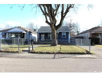 Charming single-story home with a fenced yard and inviting curb appeal on a sunny day at 4113 Fletcher Ave, Indianapolis, IN 46203
