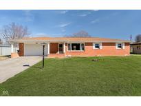 Charming single-story brick home with a well-manicured lawn, a driveway and a garage for convenient parking at 4812 Southview Dr, Anderson, IN 46013
