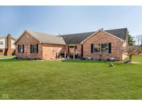 Charming brick home with a well-manicured lawn and inviting front patio, perfect for outdoor relaxation at 5079 Stonespring Way, Anderson, IN 46012