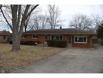 Charming brick ranch-style home with a well-maintained front yard and a paved driveway at 6636 W Ohio St, Indianapolis, IN 46214