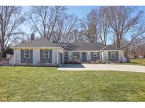 Charming brick ranch-style home with gray shutters and a well-manicured front lawn at 7844 N Audubon Rd, Indianapolis, IN 46250
