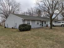 Charming single story home with light grey siding and inviting front yard at 8002 Bryan Dr, Indianapolis, IN 46227