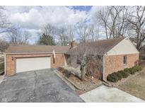 Charming brick ranch home features an attached garage and a well-maintained yard at 8225 S East St, Indianapolis, IN 46227