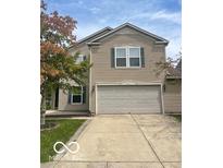 Charming two-story home featuring a spacious two car garage and well-maintained lawn at 8249 Retreat Ln, Indianapolis, IN 46259