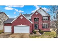 Charming two-story red brick home with a two-car garage and well-maintained front yard at 11185 Beardsley Way, Fishers, IN 46038